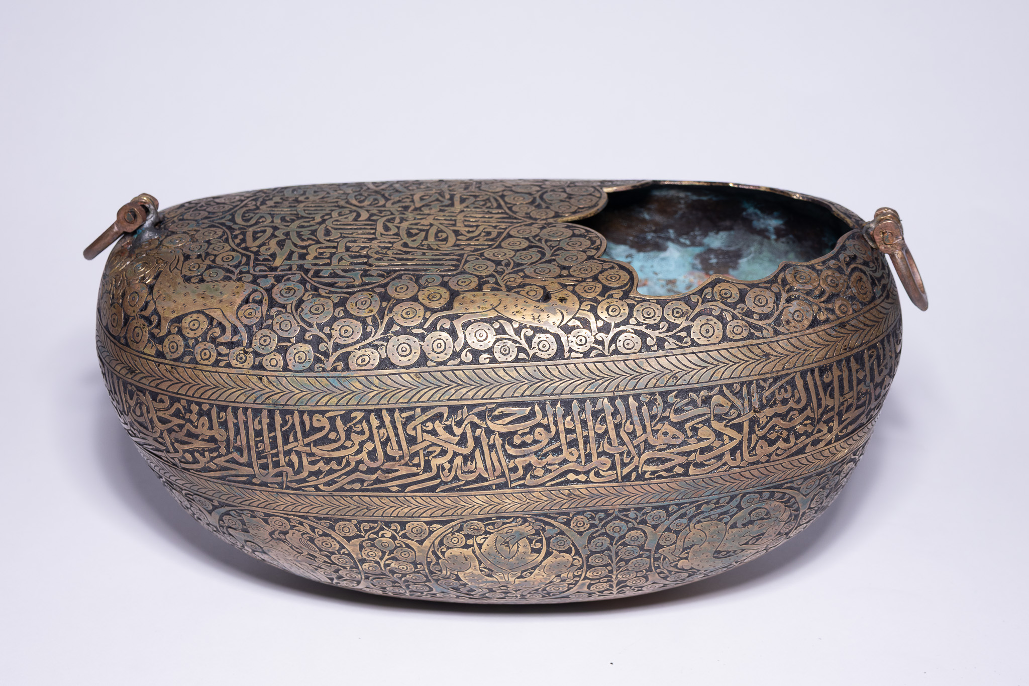 A QAJAR DAMASCENED COPPER KASHKUL (BEGGAR’S BOWL).