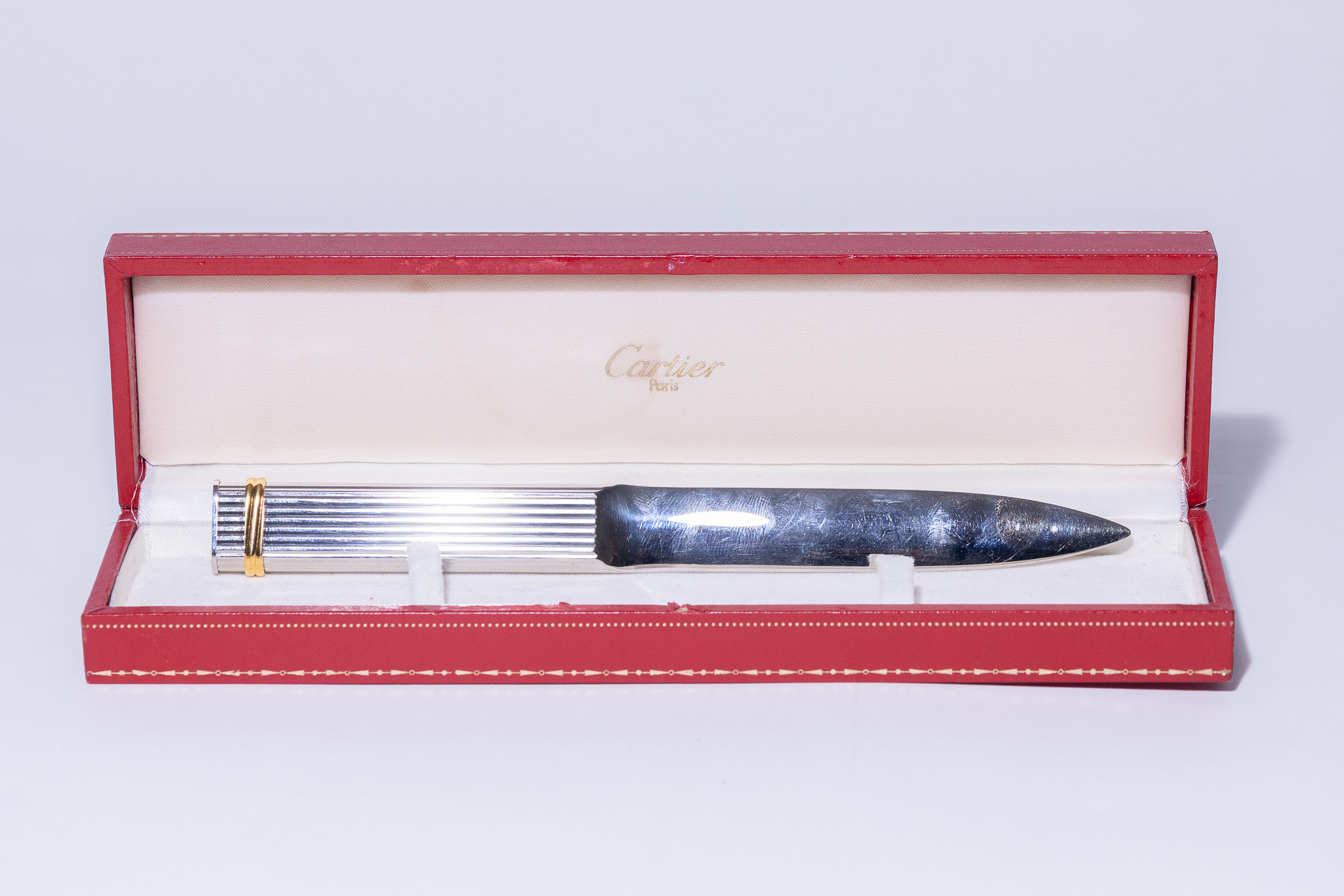 A MUST DE CARTIER GODRON PATTERN SILVER LETTER OPENER.