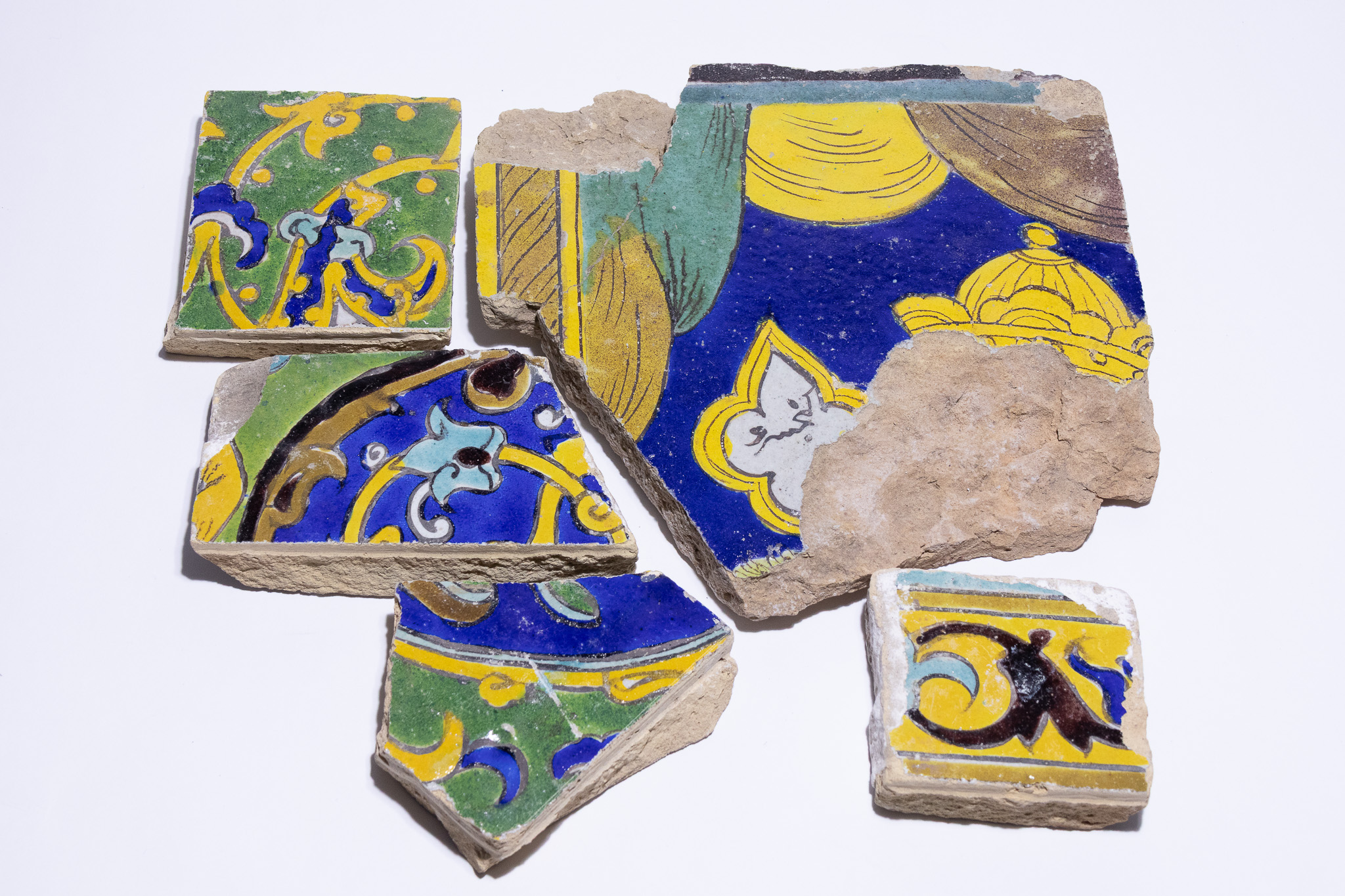 A COLLECTION OF SAFAVID CUERDA SECA POTTERY TILE FRAGMENTS, PERSIA, 17TH CENTURY.