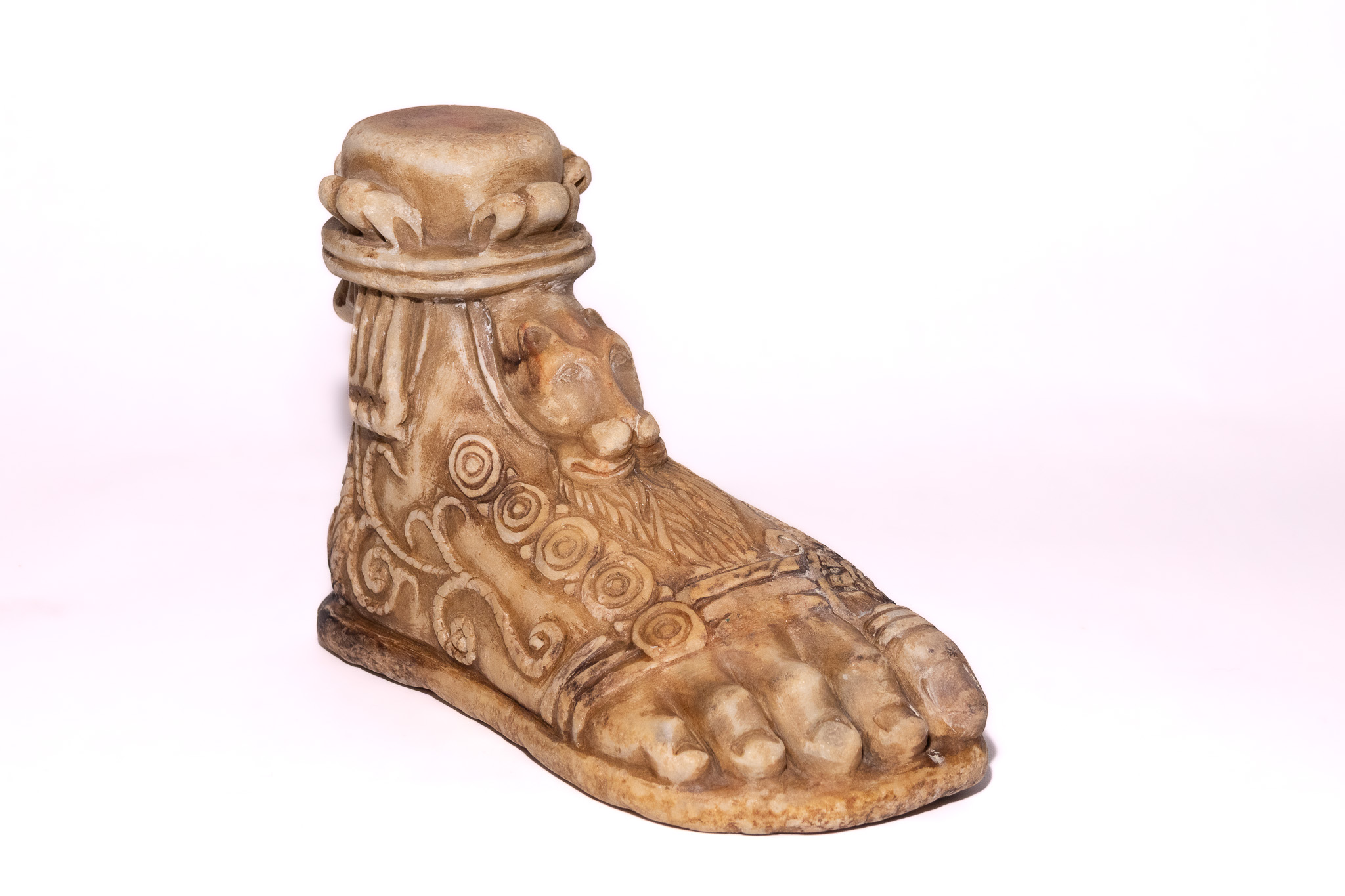 A ROMAN CARVED STONE FOOT WITH LION MASK DECORATION, CIRCA 1ST-3RD CENTURY A.D.