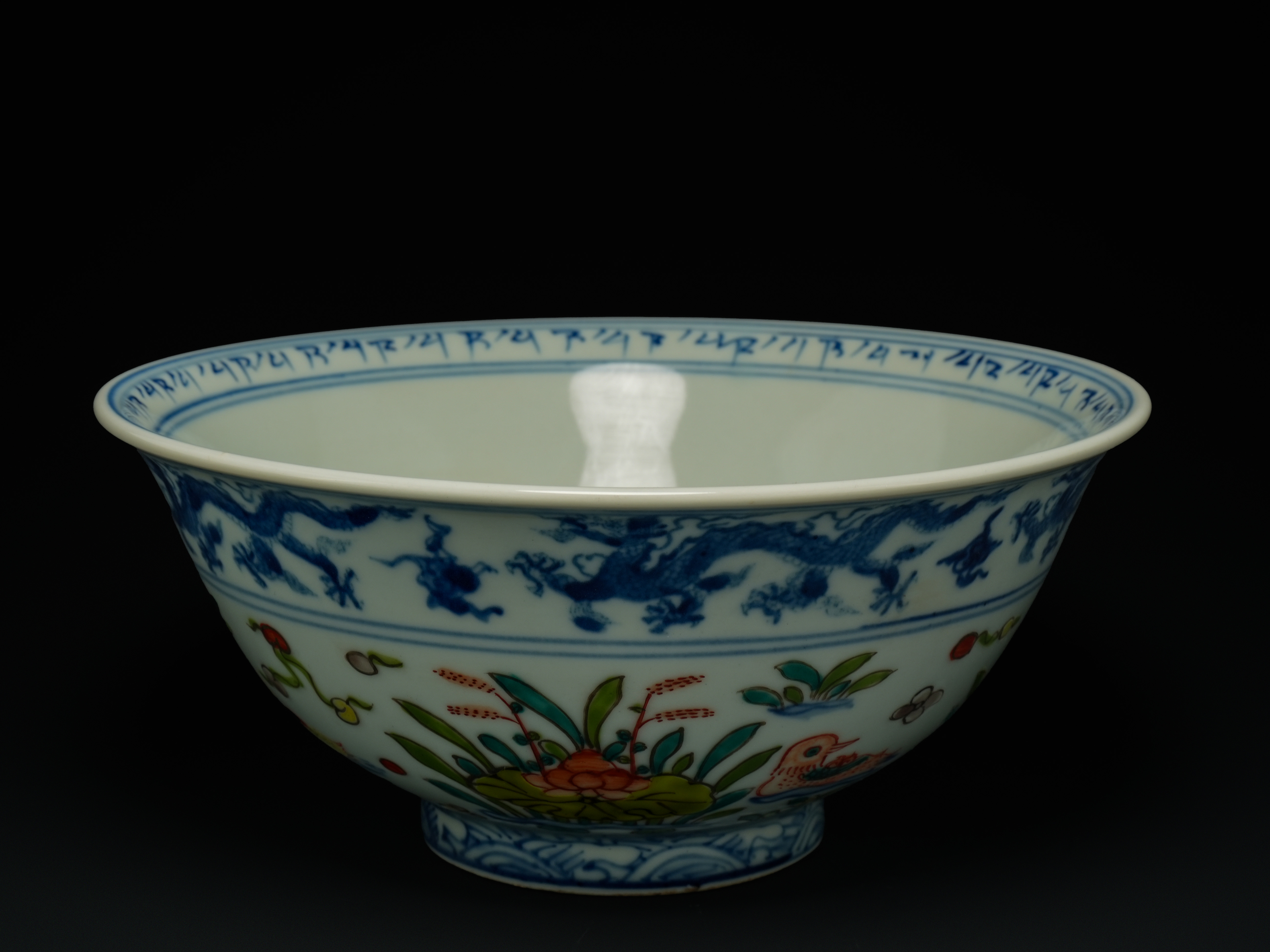A Chinese Blue and White and Famille Verte–Decorated Bowl, Xuande Mark.