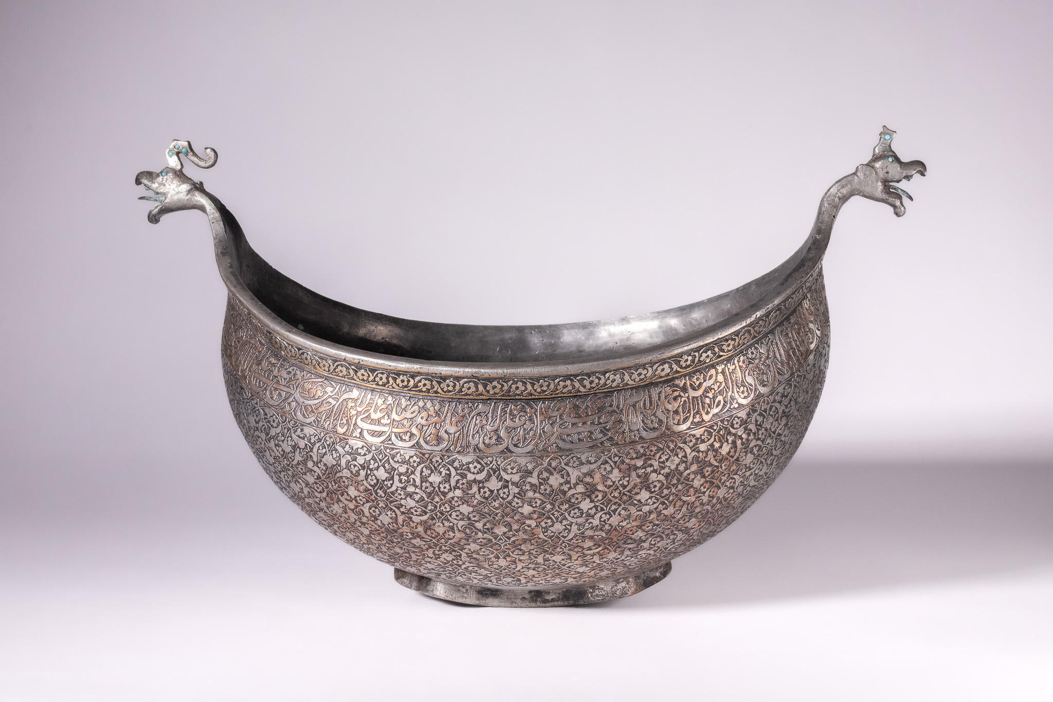 A RARE SAFAVID TINNED-COPPER KASHKUL (BEGGAR'S BOWL), PERSIA, 17TH CENTURY