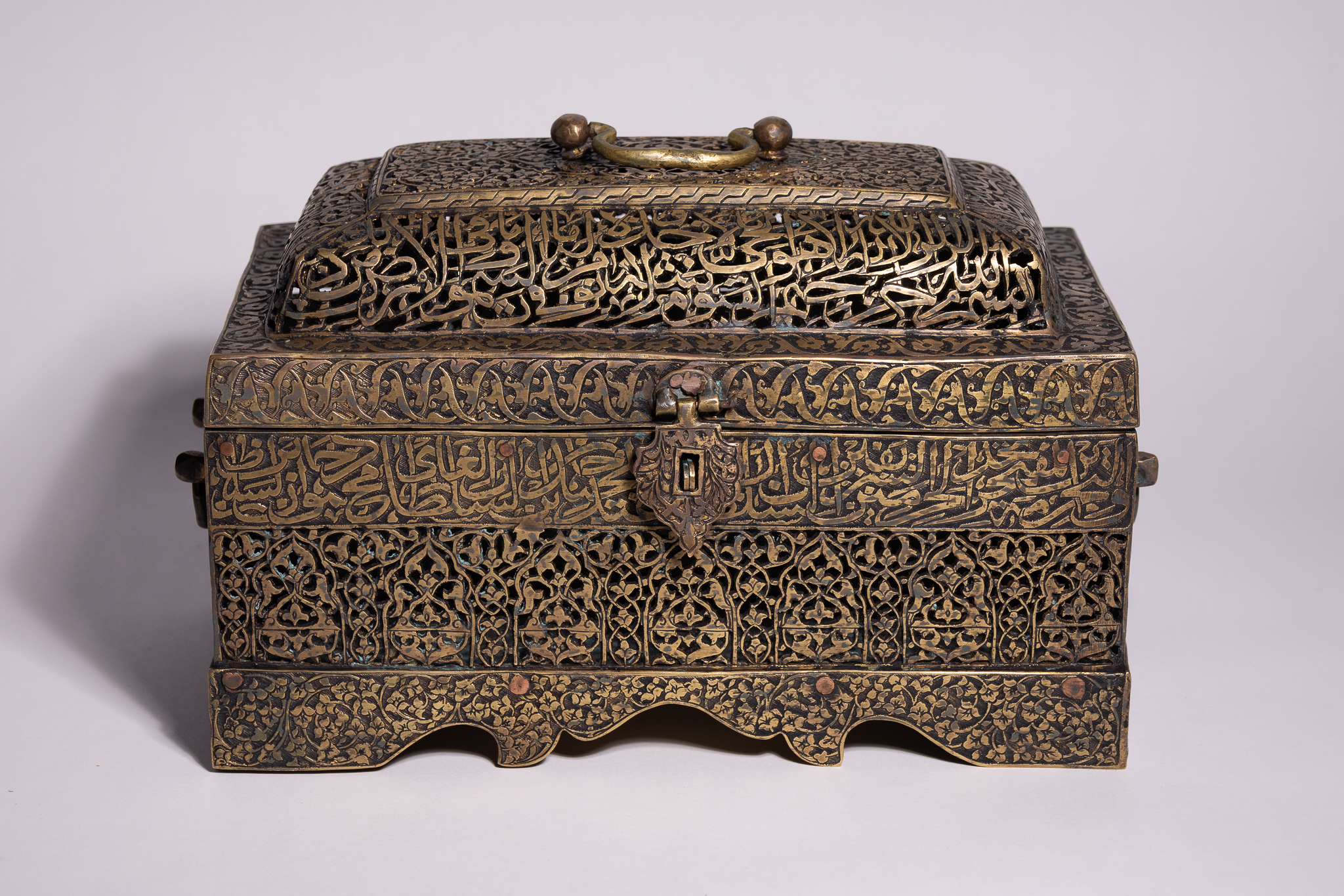 A QAJAR PIERCED AND ENGRAVED BRASS QUR'AN BOX, PERSIA, 19TH CENTURY.