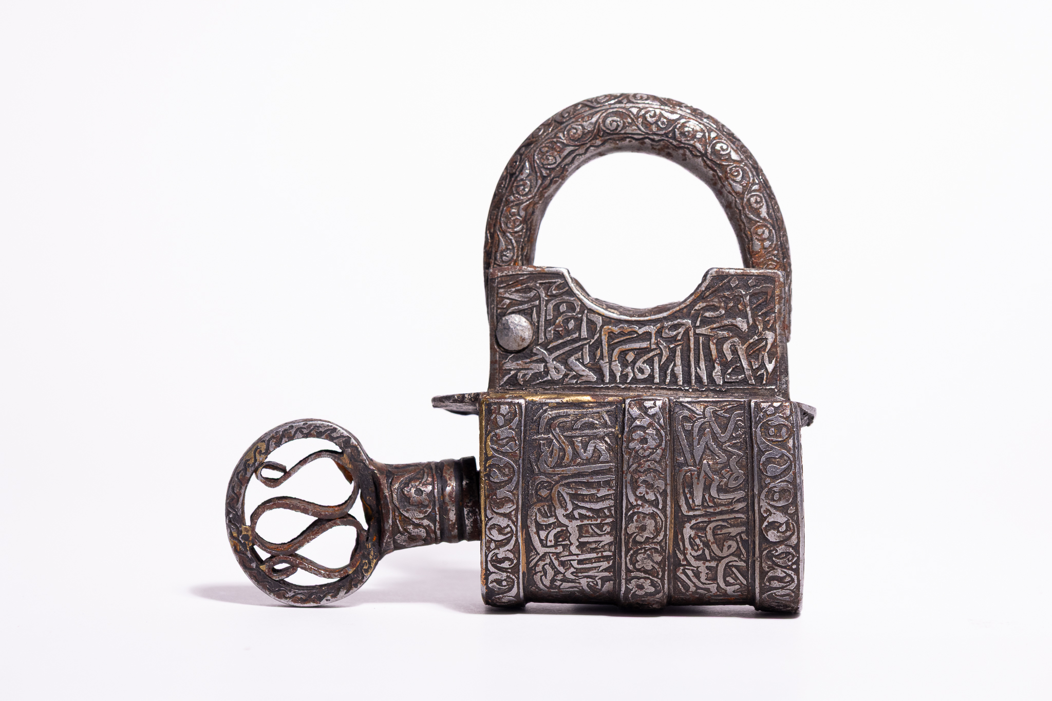A QAJAR COPPER-INLAID STEEL CALLIGRAPHIC PADLOCK AND KEY, 19TH CENTURY.