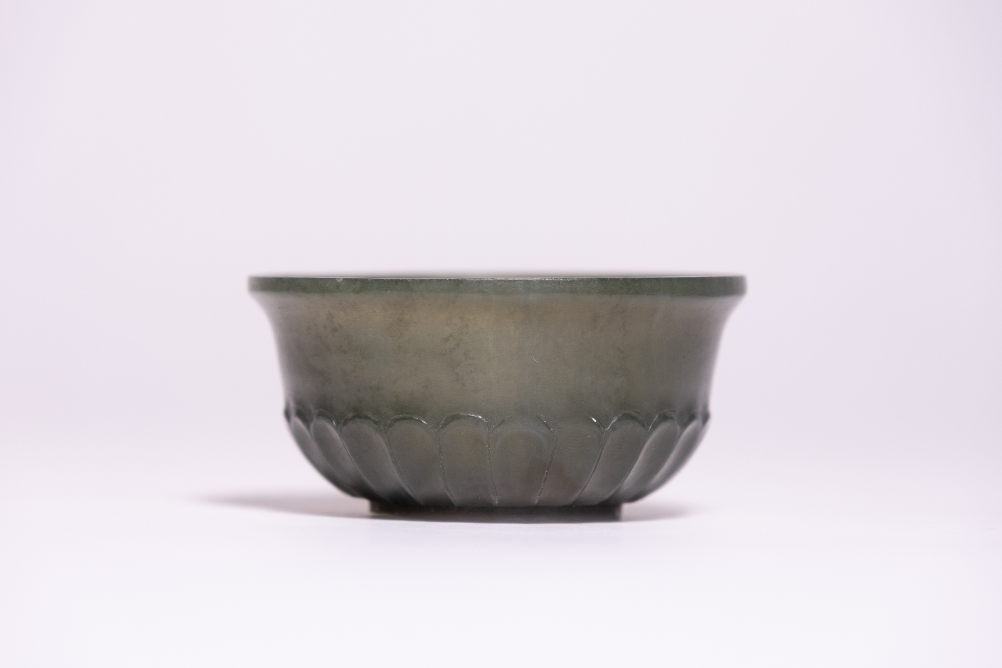 AN OTTOMAN SPINACH GREEN JADE CARVED BOWL.