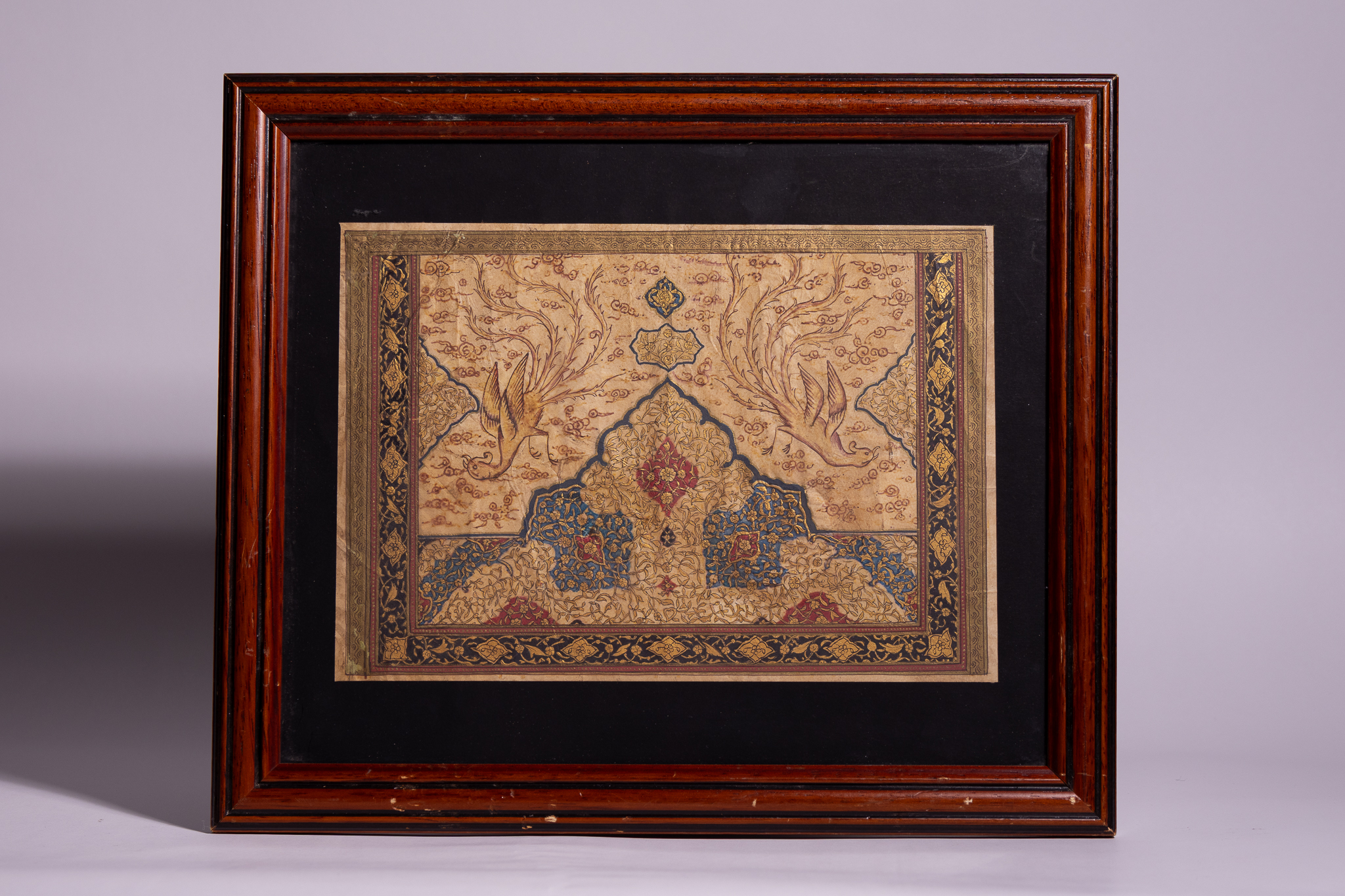 A FRAMED PERSIAN ILLUMINATED MANUSCRIPT PANEL WITH SIMORGHS.