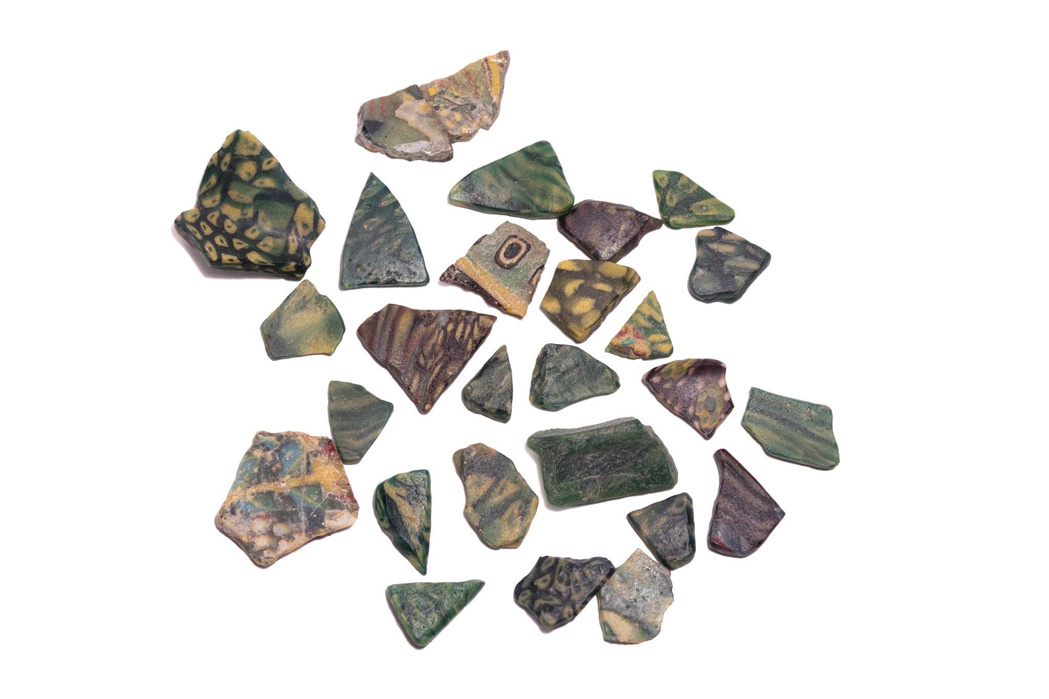 A GROUP OF ANCIENT EGYPTIAN AND ROMAN MOSAIC AND RIBBON GLASS FRAGMENTS