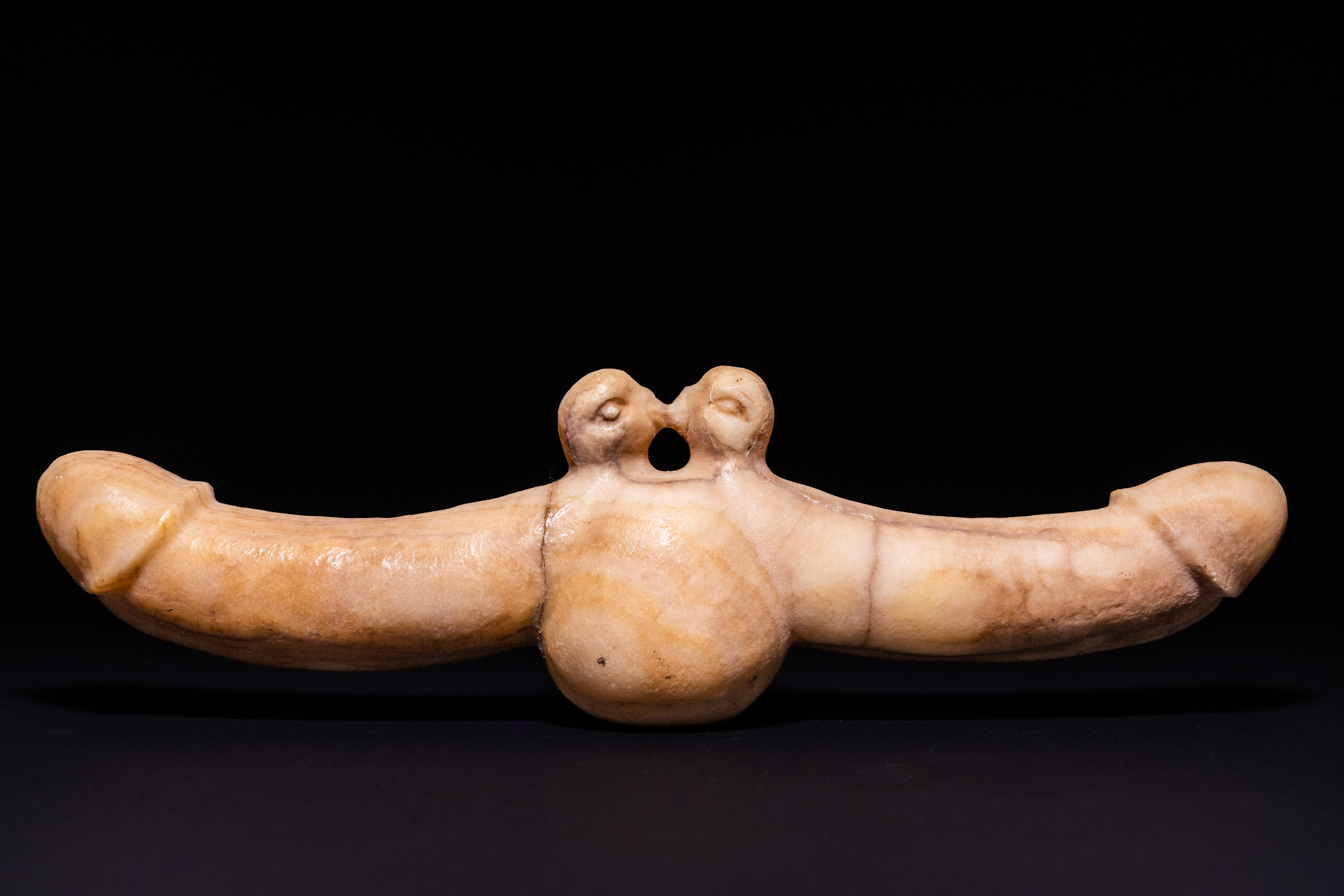 A GREEK MARBLE DOUBLE-ENDED PHALLIC AMULET, POSSIBLY CIRCA 3RD CENTURY AD.