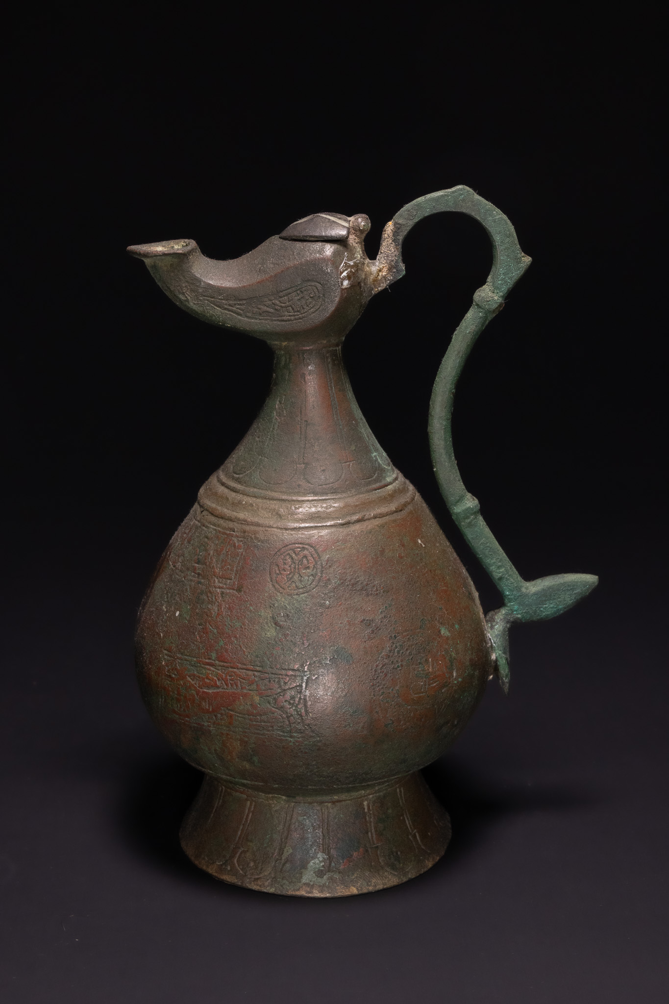 A SELJUK KHORASAN BRONZE EWER WITH LAMP-FORM SPOUT, 11TH-13TH CENTURY.