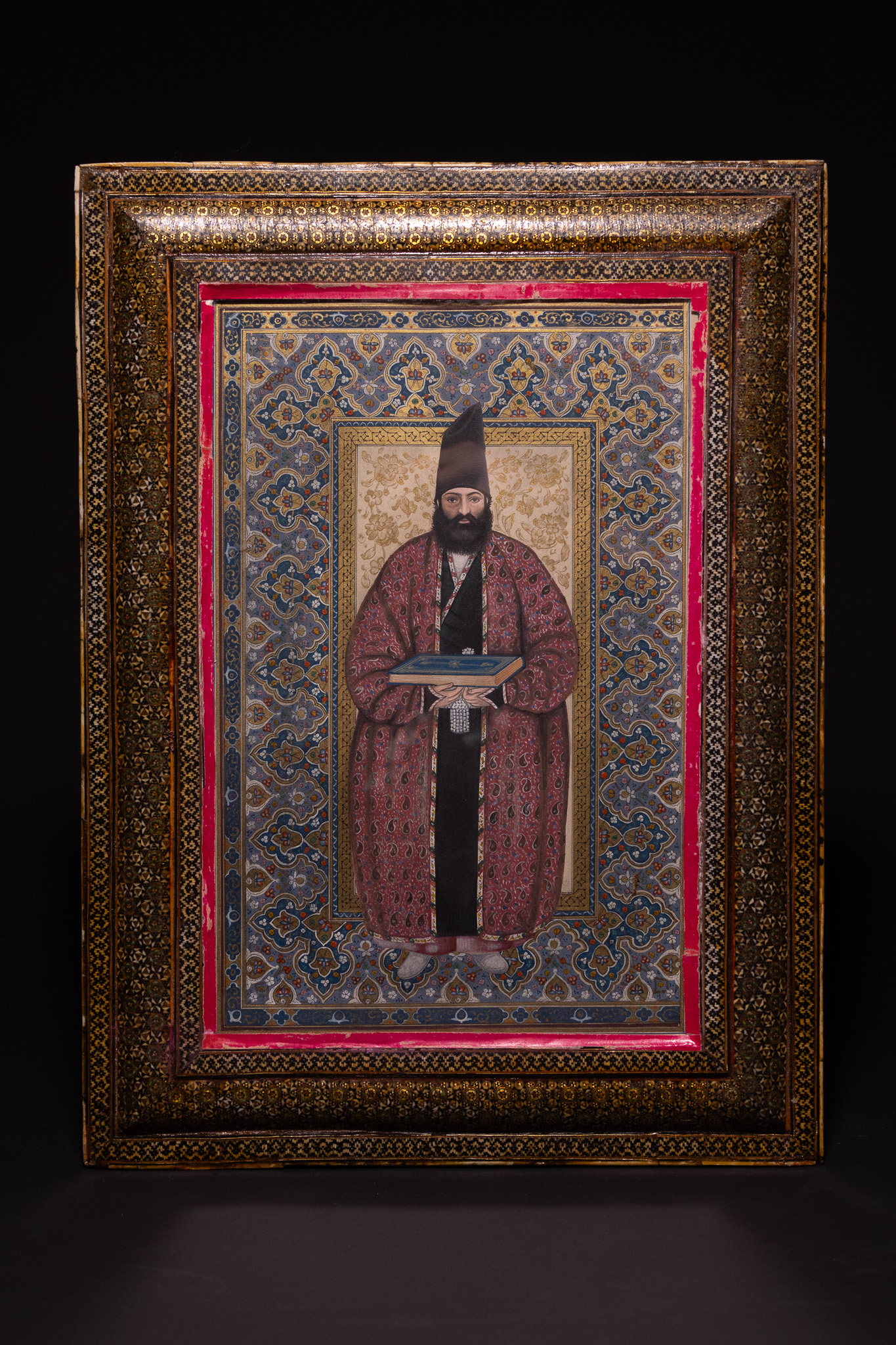 A QAJAR PORTRAIT OF HUSAYN ALI KHAN MUAYYIR AL-MAMALIK IN A DOUBLE-SIDED KHATAM-KARI FRAME, 19TH CENTURY.