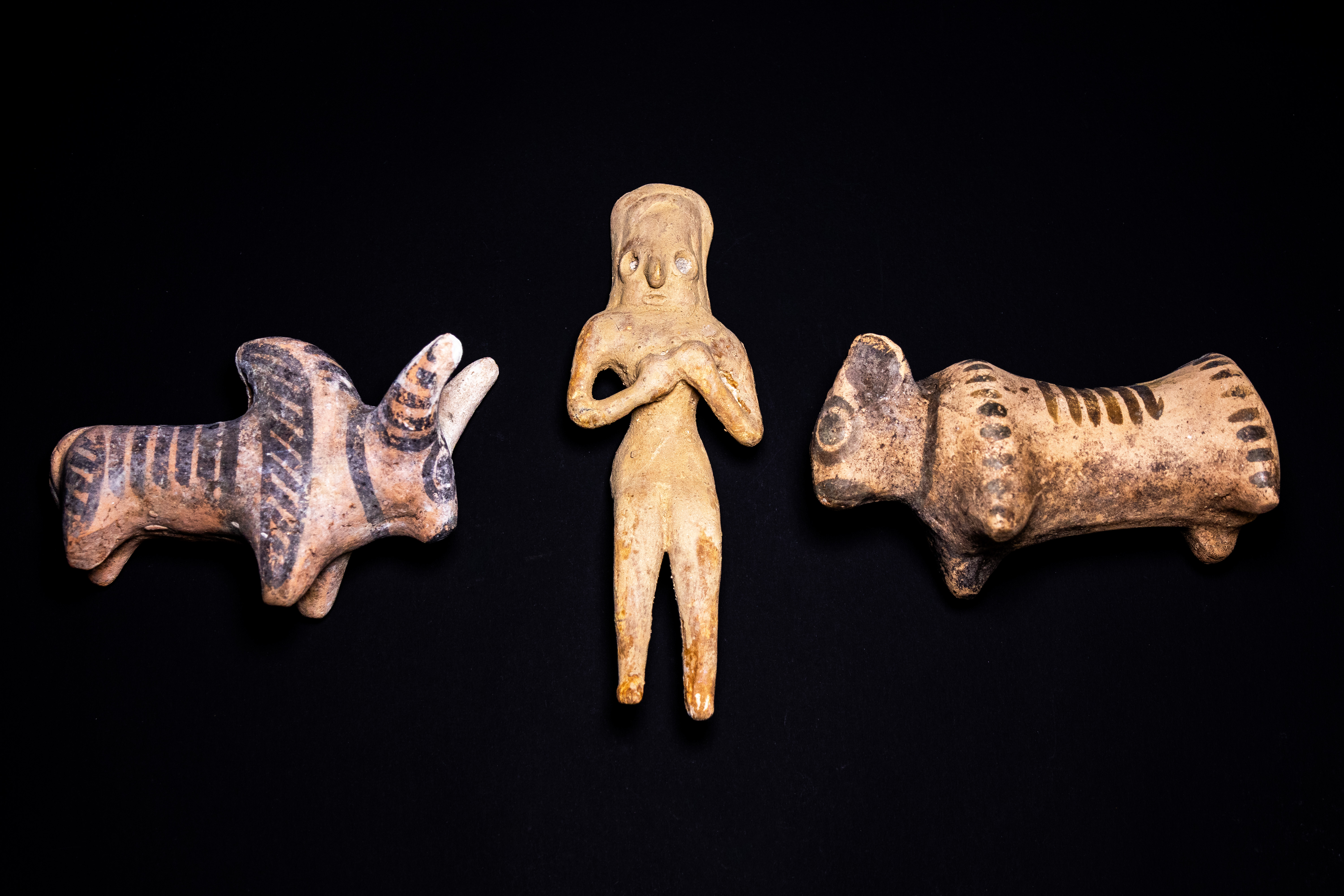 A TRIO OF INDUS VALLEY STYLE PAINTED TERRACOTTA FIGURINES, POSSIBLY CIRCA 3300–1300 BCE.