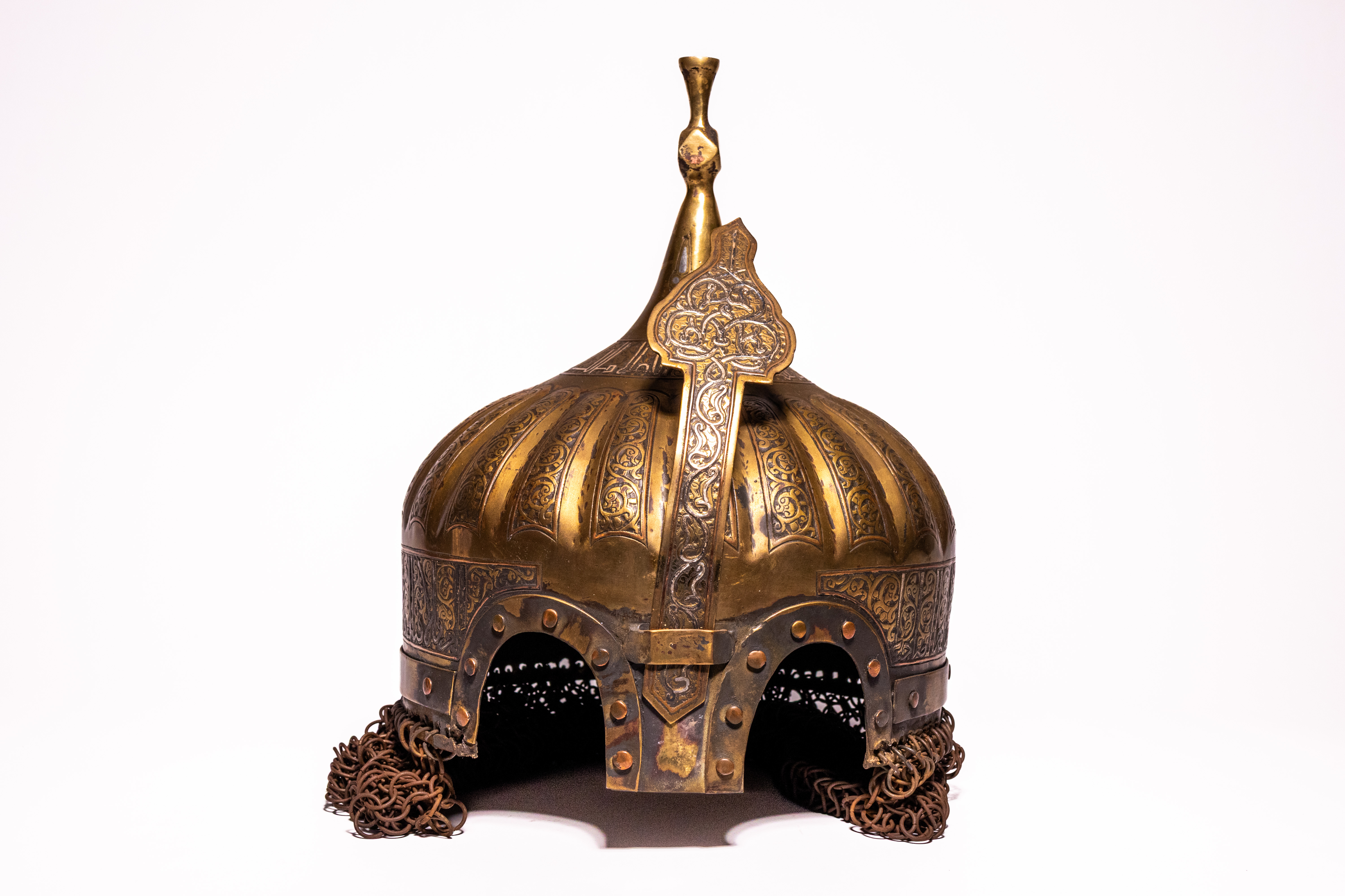 AN INDO-PERSIAN FLUTED BRASS SILVER-INLAID TURBAN HELMET KULAH KHUD.
