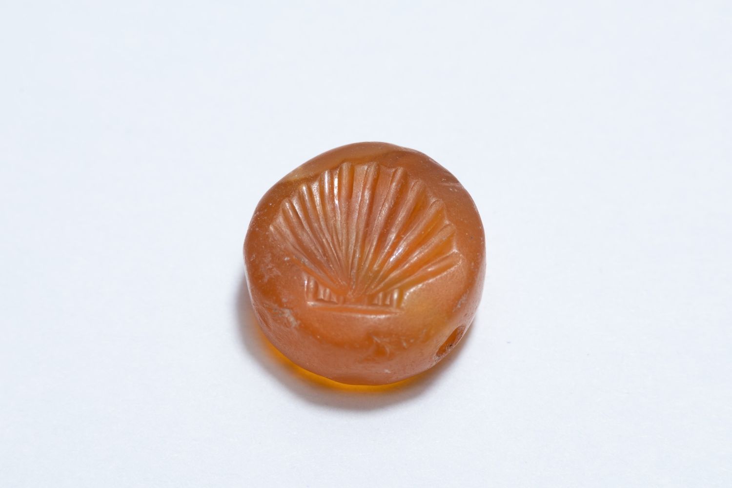 A GREEK AGATE SCARAB GEM ENGRAVED WITH A SEA SHELL, POSSIBLY CIRCA 5TH–4TH CENTURY BC.