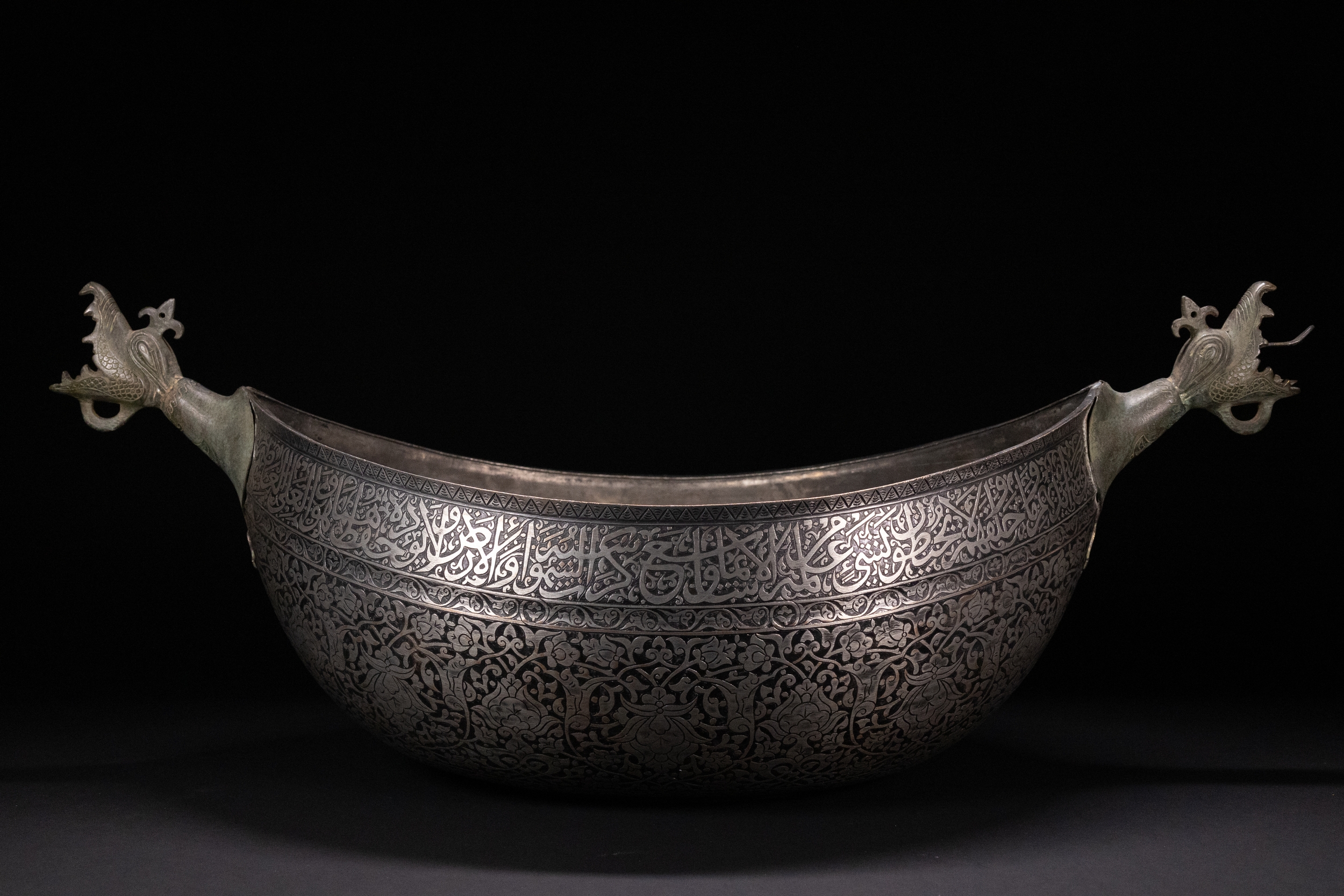 A RARE LARGE QAJAR TINNED-COPPER BOWL WITH DRAGON HANDLES, 19TH CENTURY.