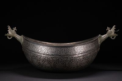 A RARE LARGE QAJAR TINNED-COPPER BOWL WITH DRAGON HANDLES, 19TH CENTURY. A wide, boat-shaped 