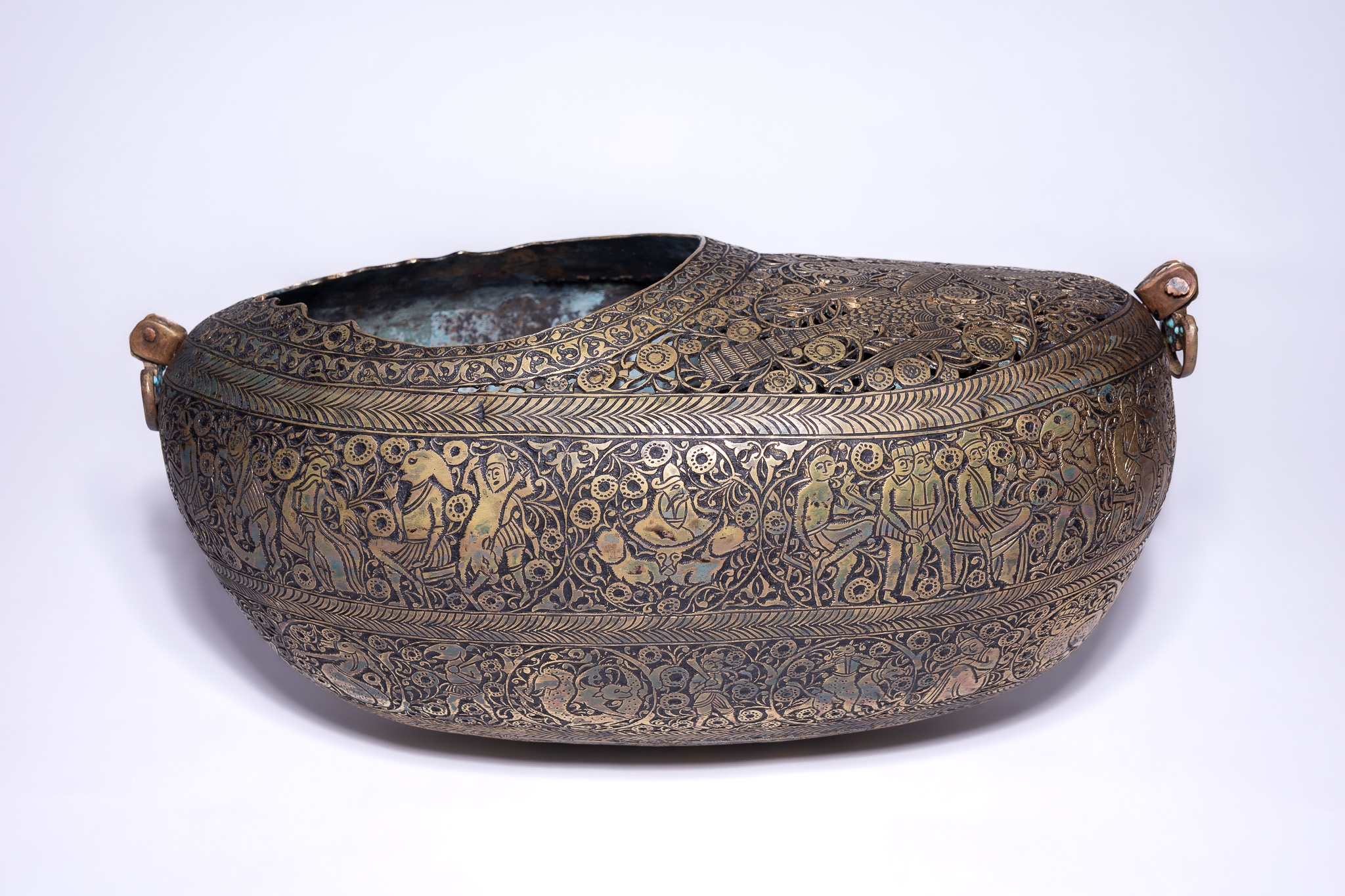 A QAJAR BRASS KASHKUL BEGGARS BOWL WITH OPENWORK DECORATION.