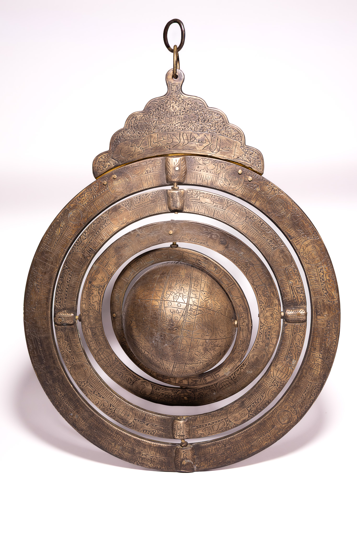 A LARGE INDO-PERSIAN ENGRAVED BRASS ARMILLARY SPHERE WITH CELESTIAL GLOBE.