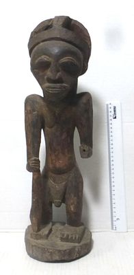 African wooden figure, man with a stick. Central Africa, first half of the 20th century, left 