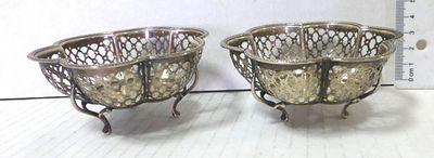 Pair of silver baskets, each with three legs. Birmingham, England, 51 gm, 50 gm