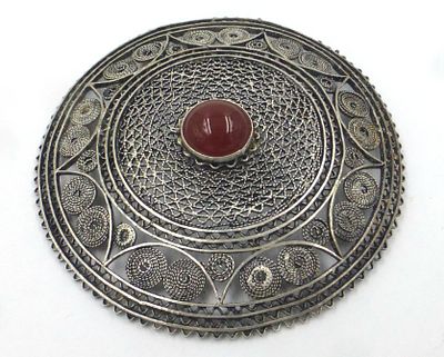 Round sterling silver pin. With filigree, set with red carnelian, diameter 7 cm, 23 gm