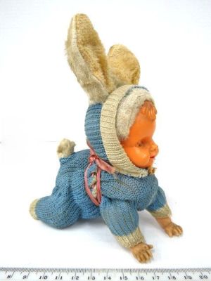 Mechanical doll, crawling baby dressed as a bunny, in need of repair