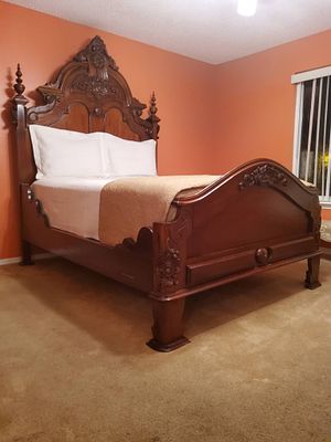 Carved Solid Wood Bedstead. A solid wood bed frame featuring exceptionally ornate carvings on 