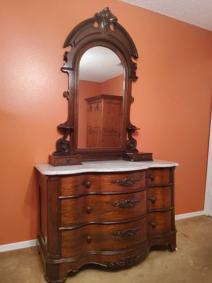Victorian-Style Wooden Dresser with Marble Top and Mirror. Victorian-style dresser featuring a 