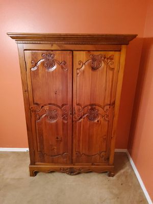 Solid Wood Armoire With Interior Drawers and Shelving. Solid wood armoire featuring double doors 