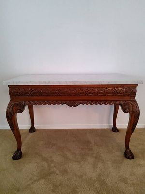 Carved Wood Console Table with Marble Top. A rectangular console table with a mahogany finish 
