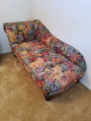 Floral Upholstered Chaise Lounge with Tufted Accents. Floral upholstered chaise lounge featuring 