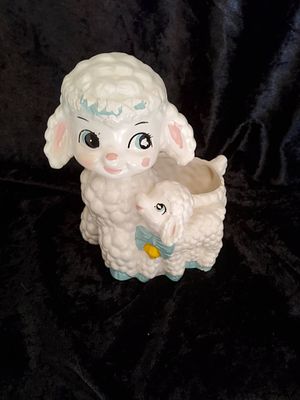 Ceramic Lambs Keepsake Holder. A ceramic lamb featuring a mother lamb with a baby lamb detail. 
