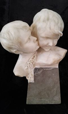 Marble Sculpture of Two Children on Stone Base. Carved marble bust on a stone base, depicting a 