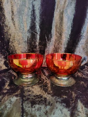 Pair of Red Glass Compote Bowls. A pair of red glass compote bowls with a radiant, reflective 