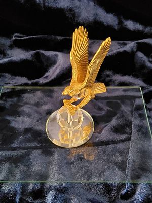 Golden Eagle Figurine. Gold-tone eagle figure in a flight pose atop a faceted crystal base. 