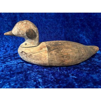 Wooden Duck Decoy Natural Wood Tones Weathered Finish Vintage Style. A vintage wooden duck decoy 