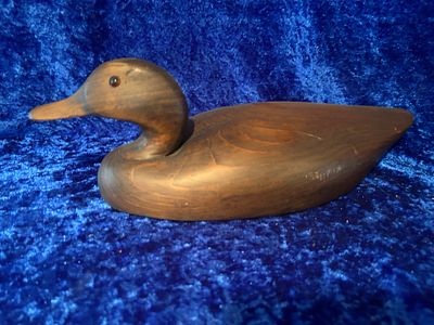 Wooden Duck Decoy Hand-Carved Dark Brown Finish. Dark brown wooden duck decoy, hand-carved with 