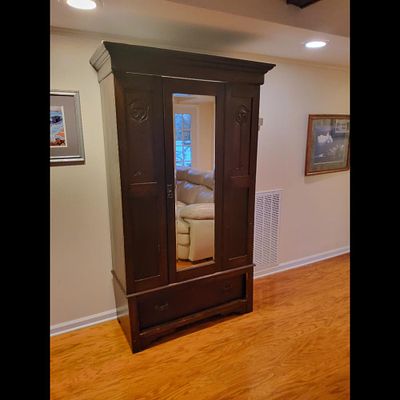 Antique Armoire Wardrobe - Mirror, Drawer, Carved Accents. An antique armoire in a dark wood 