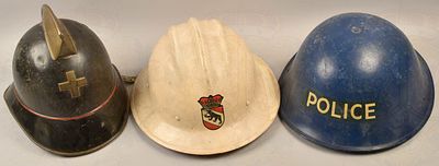 2 police helmets/1 fire brigade helmet UK and Switzerland. 2 Polizeihelme und 1 Feuerwehrhelm 