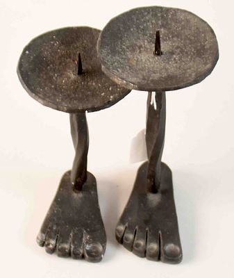 2 Candlesticks. 2 candlesticks, hand-forged iron/blackened, base plate as a stylized human foot 