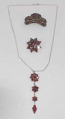 Bohemian Garnet jewelery. 3 pieces of Bohemian garnet jewelry, circa 1930, 2 brooches, 1 pendant 