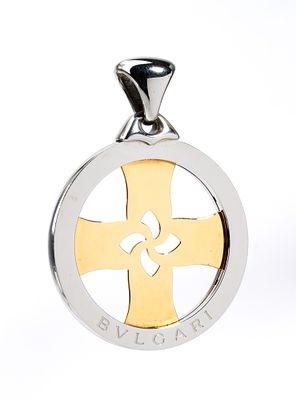 BULGARI - Openwork cross-shaped pendant in 18k yellow gold, set within a steel frame. Signed 