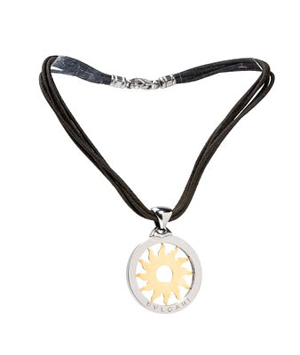 BULGARI - a pendant depicting a 18k yellow gold sun, within a steel ring, suspended from leather 