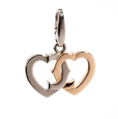 CARTIER - 18k white and yellow gold, featuring a stylised design of a pair of intertwined hearts. 