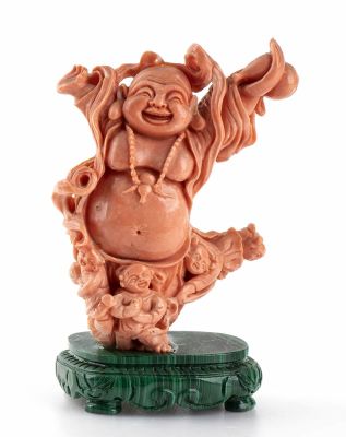 A Momo or Cerasuolo coral (Corallium Elatius) sculpture depicting a smiling Buddha with 