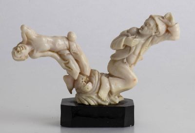 A Bok&egrave; coral (Corallium Secundum) carving depicting two male figures. Black marble base. 