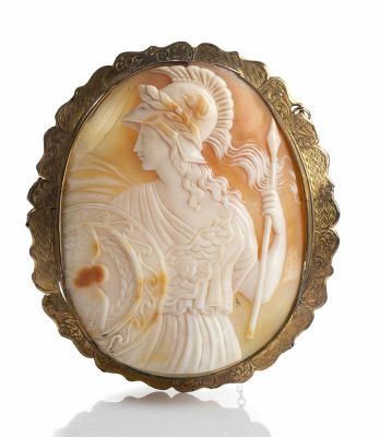 Ancient carved shell cameo depicting warrior with shield and spear. Mounting in golden metal. 