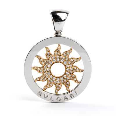 BULGARI - 18k yellow gold pendant depicting a sun with pav&eacute; set diamonds in a steel frame. Signed 