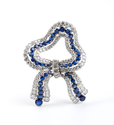Platinum diamond sapphire ribbon brooch. Platinum setting embellished with diamonds and 