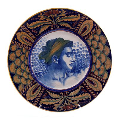 Plate with a male profile, rim decorated with peacock-tail motifs and flowers Ceramic 44,5 cm 