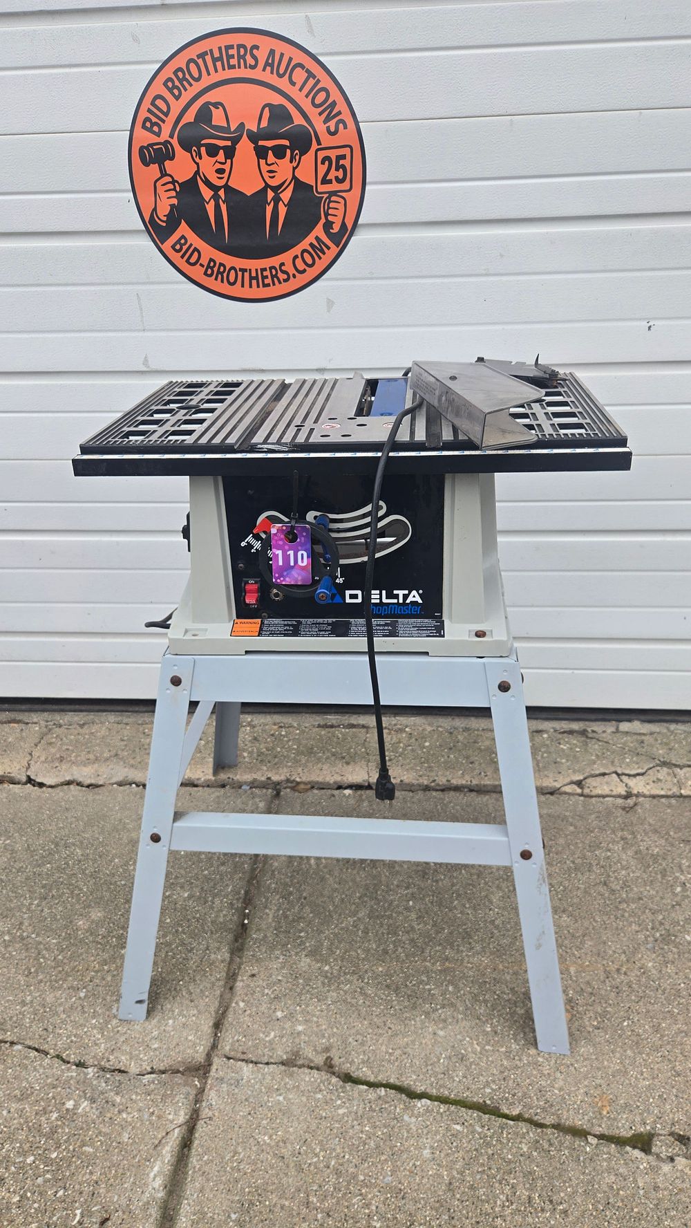 Lot 110: Delta 10-inch table saw with stand
